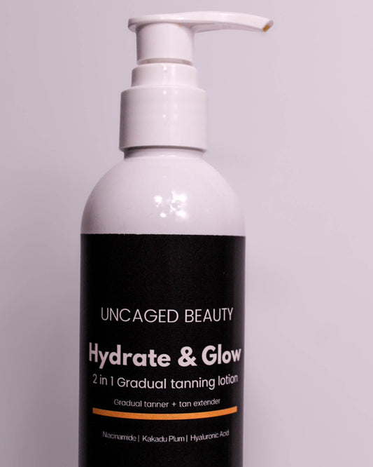 Bottle of 'Hydrate & Glow' tanning lotion by Uncaged Beauty on a gray background